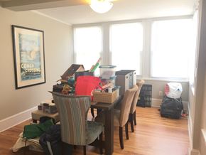 Philadelphia apartment for rent - the dining room is cluttered with boxes and a table with chairs