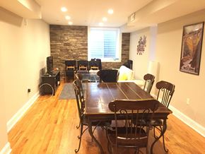 Philadelphia apartment for rent - a dining room with a table and chairs and a stone wall
