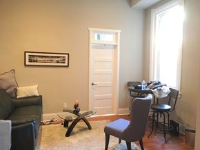 Philadelphia apartment for rent - a living room with a desk and a door with a window