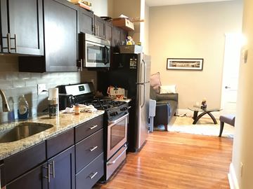 Philadelphia apartment for rent - a kitchen with black cabinets and stainless steel appliances