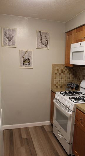 S. Weymouth apartment for rent - A kitchen with a white stove and cabinets.