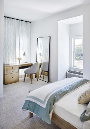 Amityville apartment for rent - a bedroom with a bed and a desk with a mirror