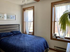 Madison apartment for rent - a bedroom with a bed and two windows