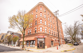 Madison apartment for rent - A red brick building with awnings on the ground floor.