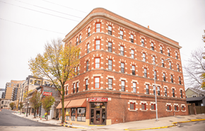 Madison apartment for rent - A red brick building with a sign that says "Pam's Celebration" on the front.