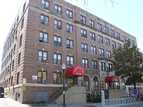 Madison apartment for rent - a brick building with a red awning in front of a street