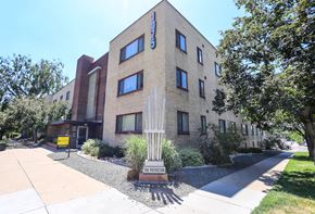 Denver apartment for rent - a brick building with a statue in front of it