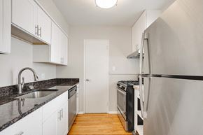 Denver apartment for rent - a kitchen with stainless steel appliances and white cabinets