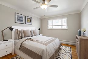 Denver apartment for rent - a bedroom with a bed and a ceiling fan