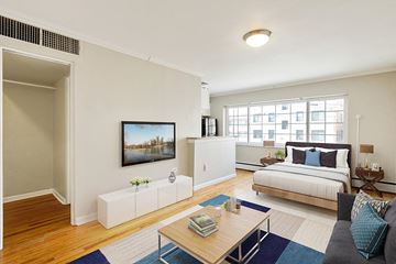 Denver apartment for rent - an open living room with a bed and a television