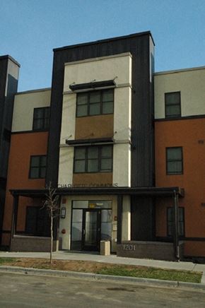Minneapolis apartment for rent - The building is a modern structure with a flat roof and a large glass window.