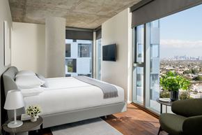West Hollywood apartment for rent - a hotel room with a bed and a view of the city