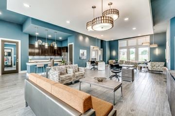 Fort Worth apartment for rent - A modern living room with a grey sofa and a wooden coffee table.