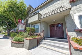 North Hollywood apartment for rent - the front of a house with stairs and a sign in front of it