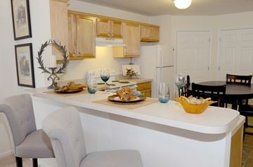 Valley City apartment for rent - A kitchen with a white counter and a grey chair.