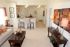 Valley City apartment for rent - A living room with a couch, coffee table, and bar stools.