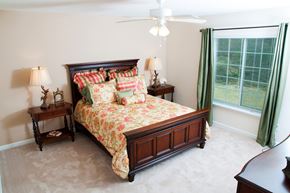 Valley City apartment for rent - A bedroom with a large bed and a ceiling fan.