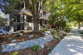 Denver apartment for rent - front view of the building with sidewalk and trees