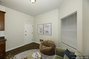 San Francisco apartment for rent - A living room with a brown chair and a green couch.
