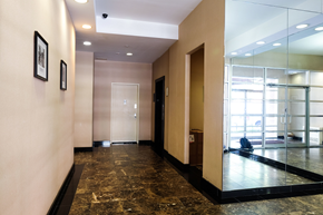 New York apartment for rent - a hallway with glass doors and a marble floor