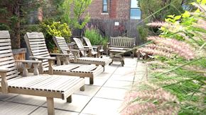 New York apartment for rent - a group of wooden benches in a garden