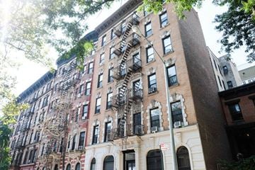 New York apartment for rent - the apartment building has a fire escape on the side of it