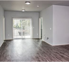 East Lansing apartment for rent - the living room of an empty apartment with a sliding glass door