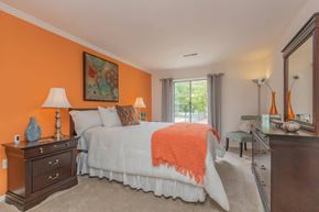 Roanoke apartment for rent - a bedroom with a bed and a dresser and a window