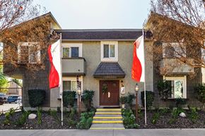 Tarzana apartment for rent - a house with two flags in front of it