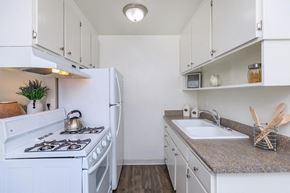 Studio City apartment for rent - a kitchen with white appliances and a sink and a stove