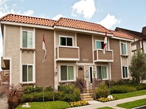 Northridge apartment for rent - Exterior of Cypress Point Apartments in Northridge, featuring a two-story residential building with a red tile roof, lush landscape, and walkway leading to the entrance.