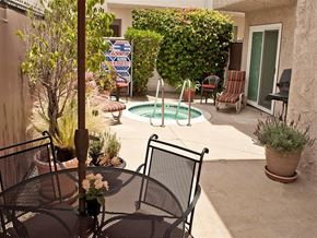 Northridge apartment for rent - a patio with a table and chairs and a swimming pool