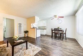 Van Nuys apartment for rent - Open concept living room and dining with plank flooring in a one bedroom apartment at the Promenade Apartment in Van Nuys, CA
