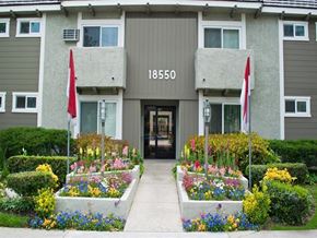 Tarzana apartment for rent - the front entrance of an apartment building with flower beds