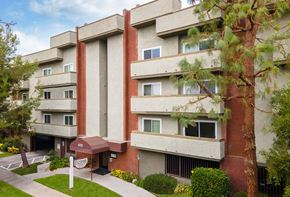 Sherman Oaks apartment for rent - An areal image of the Hallmark Apartments in Sherman Oaks, CA, showcasing the front of the building and the curb