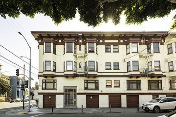 San Francisco apartment for rent - A white building with brown trim and a balcony on the second floor.