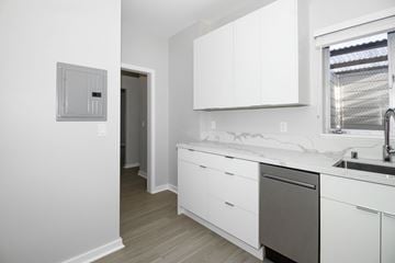 San Francisco apartment for rent - A white kitchen with a dishwasher and a window.