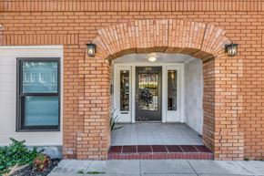 San Francisco apartment for rent - A red brick building with a white door and a window.
