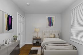 San Francisco apartment for rent - A bedroom with a bed, nightstand, and a painting on the wall.