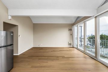 San Francisco apartment for rent - A kitchen with a refrigerator and wooden floors.