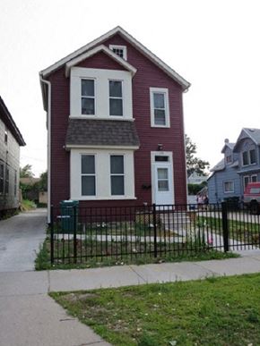 St. Paul apartment for rent - A red house with white trim and a black fence.