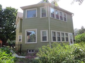 St. Paul apartment for rent - A green house with white trim and windows.
