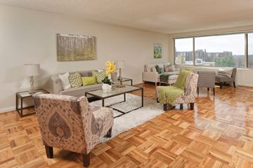 Washington apartment for rent - A living room with a patterned chair and a glass coffee table.