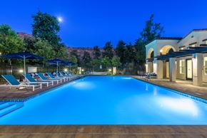 Camarillo apartment for rent - a swimming pool with chairs and umbrellas at night