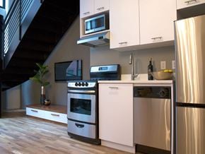 Yonkers apartment for rent - a kitchen with stainless steel appliances and white cabinets