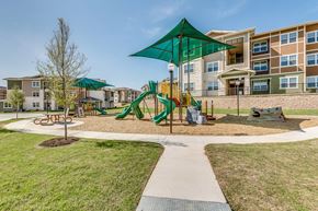 Fort Worth apartment for rent - Beautiful outdoor play area designed with colorful equipment, safety surfacing, and shaded canopies to encourage active outdoor fun.