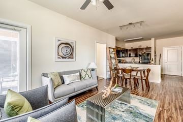 Fort Worth apartment for rent - A living room with a grey couch and a coffee table.