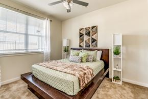 Fort Worth apartment for rent - Spacious bedroom retreat featuring plush carpeting, oversized windows, and a calming neutral color palette designed for comfort and relaxation.