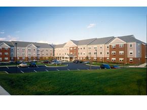 Bethlehem apartment for rent - an exterior view of an apartment building with a parking lot