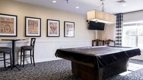 Bladensburg apartment for rent - a conference room with a projector screen and a table with a black cloth on it